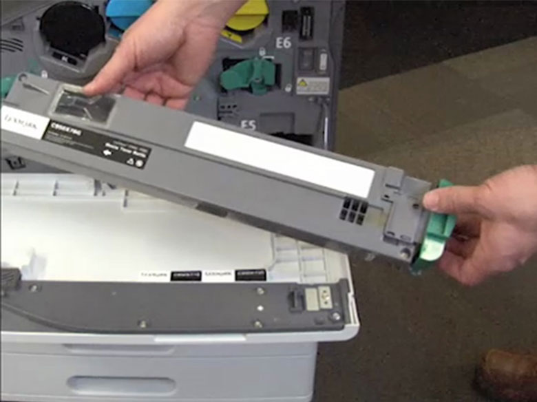 Insert the new waste toner bottle until it clicks into place