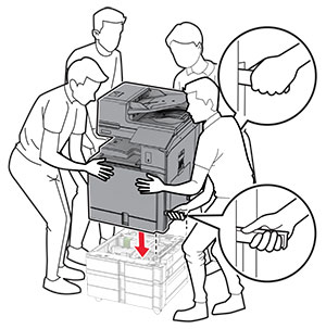 The printer is aligned and lowered into the optional trays.