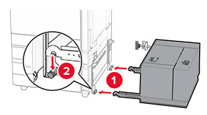 Tray is being aligned, and then pushed into the right side of the printer.