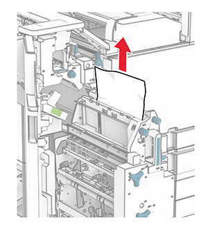 Jammed paper is removed from the top of the booklet maker.