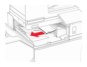 Jammed paper is removed from the paper transport bin.