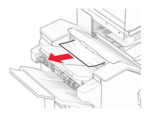 Jammed paper is removed from the finisher top bin.