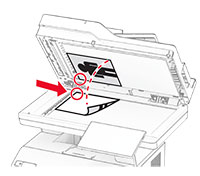 Paper is placed against the upper-left corner of the scanner.
