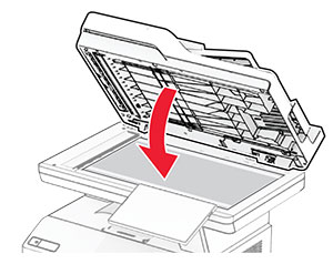 The scanner cover is closed, with the adhesives facing toward it.