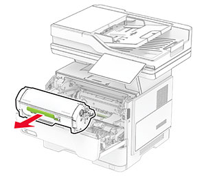 The toner cartridge is pulled out from the printer.