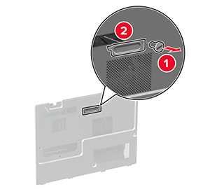 En skrue fjernes for at frigøre faxdækslet fra systemkortets afskærmning.