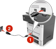 The power cord is plugged into the electrical outlet and into the printer.