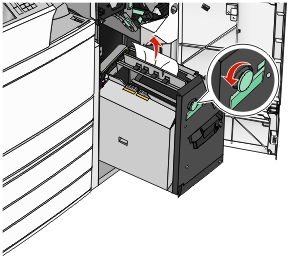 The illustration shows the paper jam being removed from staple cartridge.