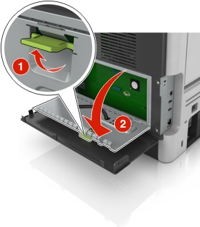 Green handle is lifted, and then pulled straight and down to open the controller board shield.