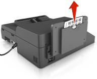 Illustration showing the cleaning kit being removed from under the exit tray