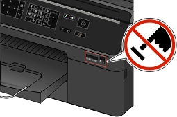 The illustration shows a warning sign to keep the user from touching the memory card slot as well as the USB and PictBridge port of the printer.