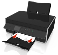 The illustration shows the jammed paper being removed.