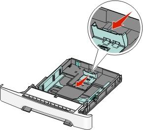 picture of fingers squeezing the paper guide tabs