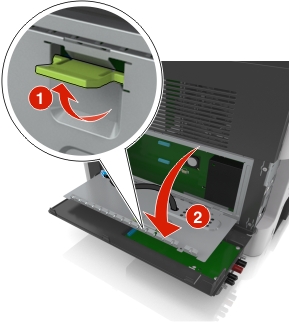 Green handle is lifted, and then pulled straight and down to open the controller board shield.